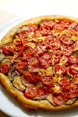 Homemade cherry tomato tart with zucchini	
