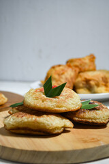 Kue Khamir or samir or Khamir cake on wooden plate. Khamir cake is a traditional snack from Pemalang, Indonesia. This cake is made from flour, butter and egg dough. Selective Focus