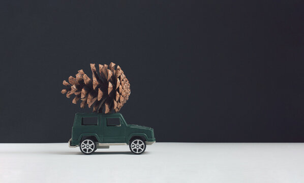 Creative idea made of pastel green toy car with core on the roof against white, black background. Minimal christmas concept. - Powered by Adobe