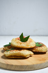 Kue Khamir or samir or Khamir cake on wooden plate. Khamir cake is a traditional snack from Pemalang, Indonesia. This cake is made from flour, butter and egg dough. Selective Focus