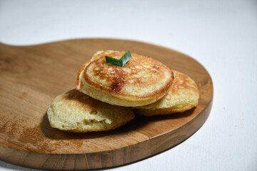 Kue Khamir or samir or Khamir cake on wooden plate. Khamir cake is a traditional snack from Pemalang, Indonesia. This cake is made from flour, butter and egg dough. Selective Focus