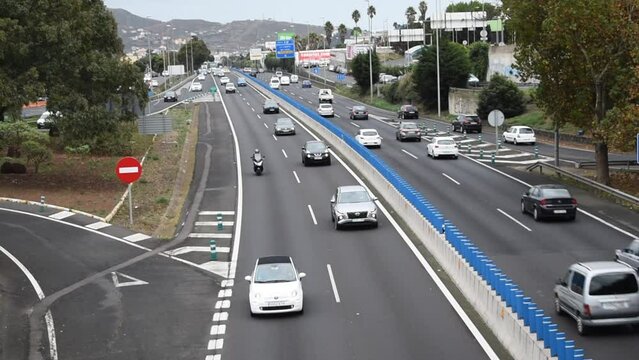 Tenerife, Spain - November 25, 2021: Highway top view with fast passing cars near Tenerife Norte Airport in the Canary Islands. Video 16 seconds. High-speed traffic on the motorway in the suburbs