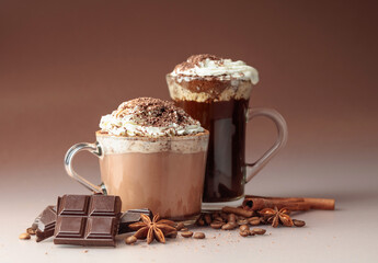 Hot chocolate and coffee with whipped cream sprinkled with chocolate crumbs.