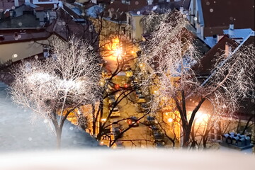 Winter city ,trees covered by snow ,medieval houses evening street , snowfall ,Tallinn old town panorama 
