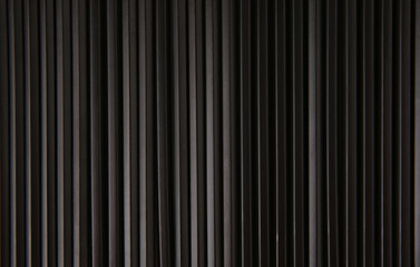 Black striped background of pencils lined up in row. Wooden texture background. Copy space.