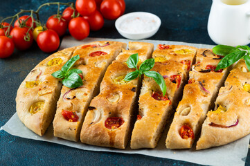 Homemade Italian Focaccia with basil and tomatoes. Italian food. Italian bread