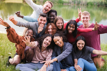 Group of friends of different origins together in the park outdoors enjoying and cheerful