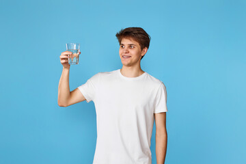 Young handsome man with drinking glass of water