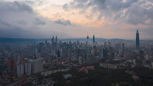 Aerial High Angle Time lapse view of  busy city streets and golden sunrise against a skyline in Kuala Lumpur, Malaysia. Prores 4KUHD Timelapse.