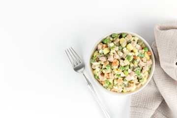 Russian Olivier salad. Russian New Year salad of vegetables, sausage and on a gray background, top view. Russian cuisine