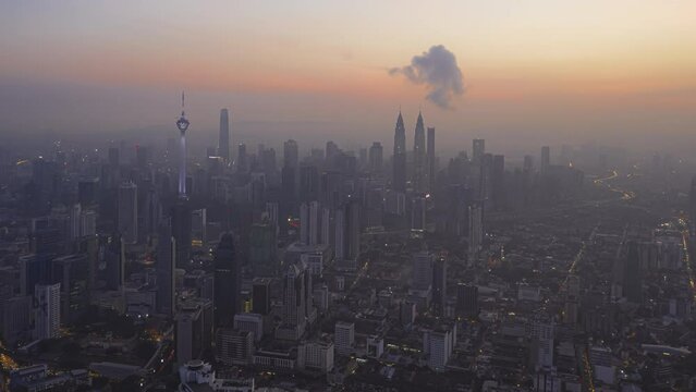 Aerial Time lapse of a misty sunrise and  busy city streets against a skyline in Kuala Lumpur, Malaysia. Prores 4KUHD Timelapase.
