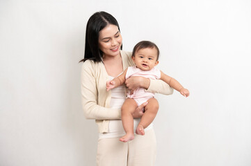 Beautiful mother and adorable baby girl are happy on white background, family, child, childhood and parenthood concept