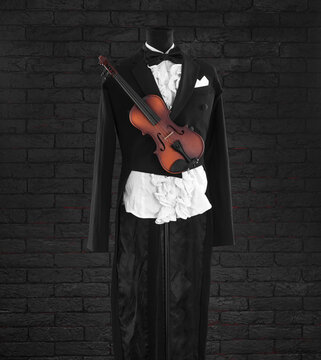 violinist black tailcoat on a black background