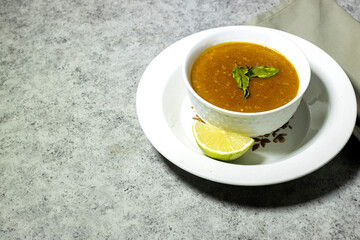 traditional bowl of spiced algerian vegetable soup named (Harira)