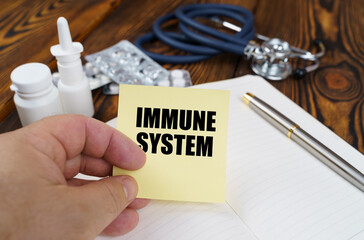 The doctor is holding a sticker with the inscription - IMMUNE SYSTEM