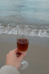 a glass of red wine on the beach 