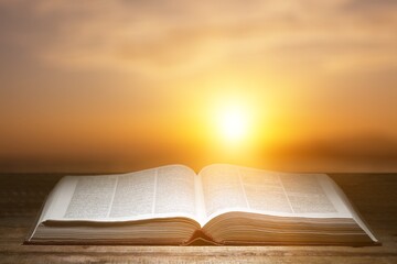 Old open book on wooden desk