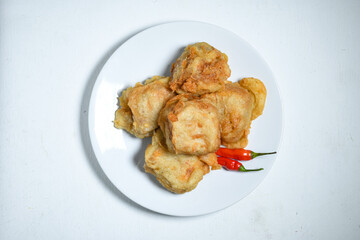 Topview of Gorengan or Fried tofu on a white plate. Fried food is one of the favorite snacks in Indonesia