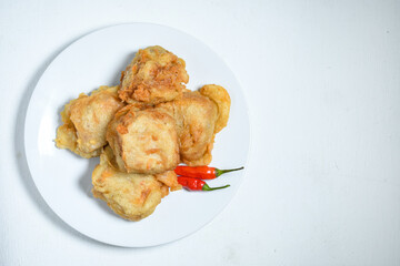 Topview of Gorengan or Fried tofu on a white plate. Fried food is one of the favorite snacks in Indonesia