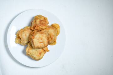 Topview of Gorengan or Fried tofu on a white plate. Fried food is one of the favorite snacks in Indonesia