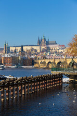 Fototapeta premium Snowy Prague Lesser Town with Prague Castle above River Vltava in the sunny Day , Czech republic