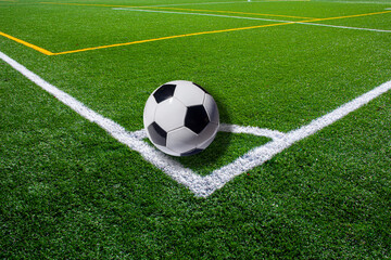Fototapeta na wymiar Soccer ball on the corner mark, synthetic grass