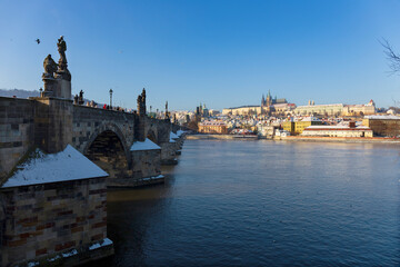 Snowy Prague Lesser Town with Prague Castle above River Vltava in the sunny Day , Czech republic