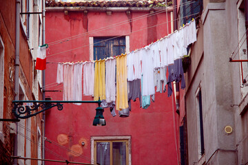 vintage style picture of an old alley with laundry lines in Venice, Italy