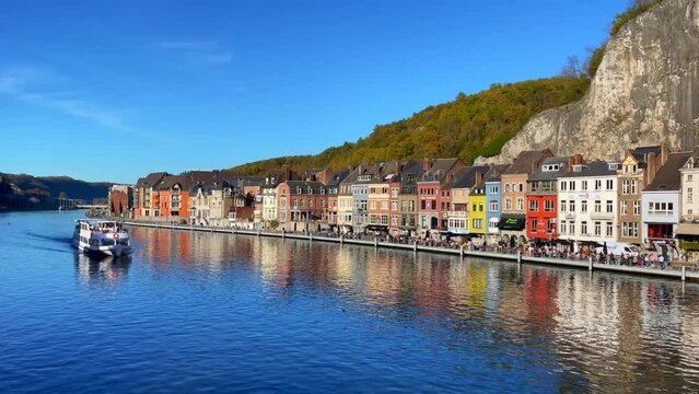 Large ferryboat sailing on the Meuse river in Dinant, Belgium