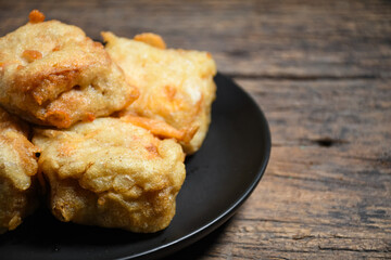 Gorengan or Fried tofu on a black plate. Fried food is one of the favorite snacks in Indonesia and chinna