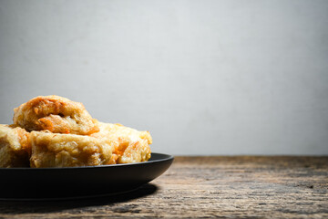 Gorengan or Fried tofu on a black plate. Fried food is one of the favorite snacks in Indonesia and chinna
