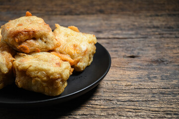 Gorengan or Fried tofu on a black plate. Fried food is one of the favorite snacks in Indonesia and chinna