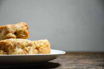 Gorengan or Fried tofu on a white plate. Fried food is one of the favorite snacks in Indonesia