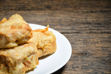 Gorengan or Fried tofu on a white plate. Fried food is one of the favorite snacks in Indonesia