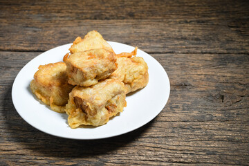 Gorengan or Fried tofu on a white plate. Fried food is one of the favorite snacks in Indonesia
