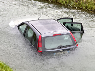 Sinking car in the river. Concept of auto car insurance
