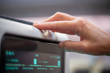 Woman hand interacting with a modern entertainment system during a flight