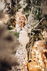 Excited child in earmuffs looking up.