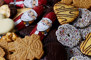 Fototapeta na wymiar Christmas sweets heap chocolate and cookies on a table. Close-up view.