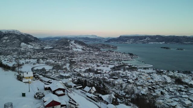 Sunset over Norwegian coastal landscape. Winter, mountains and fjord.