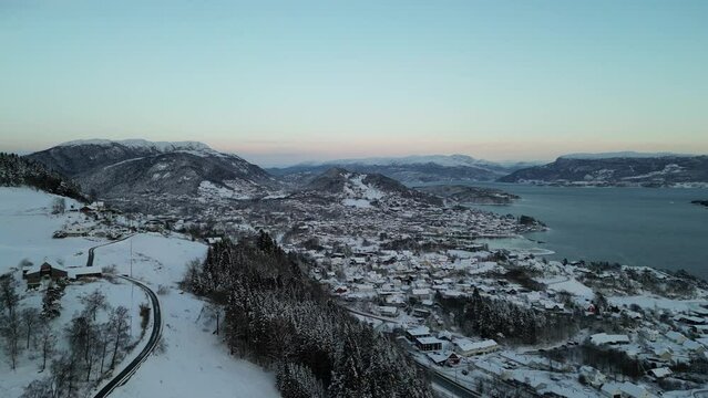 Sunset over Norwegian coastal landscape. Winter, mountains and fjord.