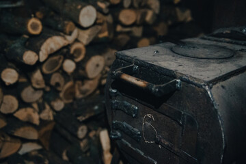 A stove in a Ukrainian soldiers' dugout with stacks of firewood