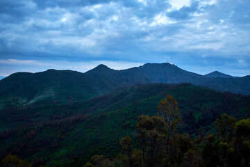 Fototapeta premium mountains in blue hour with cloudy sky and green vegetation, sierra de guadalupe in state of mexico