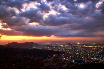 aerial view of a city in night with amazing sunset, valley of mexico, sierra de guadalupe with tultitlan state of mexico in the background