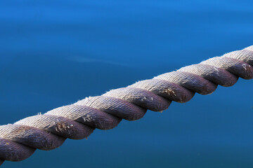 rope for mooring a ship in the port close-up