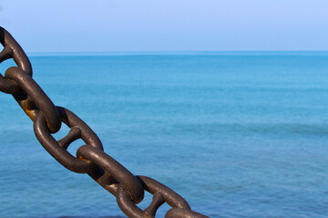 rusty anchor chain on the background of the sea background