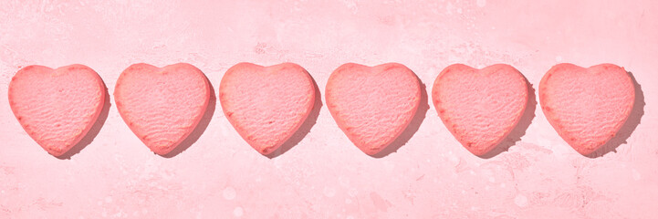 Obraz na płótnie Canvas Valentine day decorated heart shaped cookies on pink background, top view