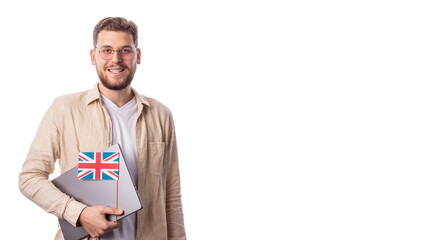 Handsome man in eyeglasses holding laptop, british flag looking to cameraand smiling, language learning comncept, language school