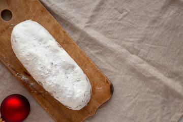 Homemade Christmas Stollen Bread on a rustic wooden board, top view. Flat lay, overhead, from above. Space for text.