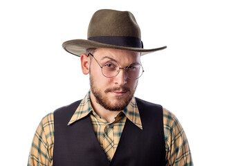 Young caucasian male in cowboy hat and eyeglasses posing against white background in studio, looking directly to camera